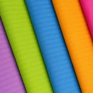 May include: A close-up of five colorful fabrics in shades of purple, green, blue, orange, and pink. The fabrics have a textured, ribbed surface, and are arranged diagonally across the frame, showcasing a vibrant array of colors.