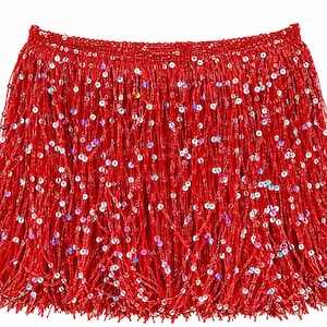 May include: A bright red skirt featuring a dense layer of long, thin fringe strands. The skirt is embellished with numerous small, iridescent, circular sequins scattered throughout the fringe, creating a shimmering effect against the red base.