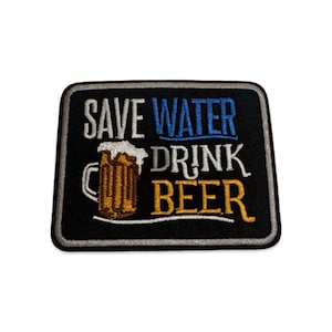 May include: A rectangular embroidered patch with a black background and a silver border. It features a graphic of a beer mug with white foam and the text "SAVE WATER" in white and blue, "DRINK" in white, and "BEER" in yellow, all stitched in thread.