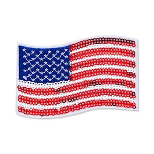 May include: A waving American flag patch with a white border. The flag features a blue field with white stars and red and white stripes, all made of sequins.