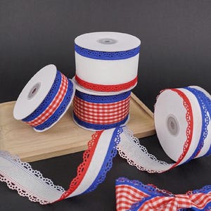 May include: Spools of decorative ribbon in red, white, and blue. Some spools feature a gingham pattern, while others have solid colors with a scalloped edge. The ribbons are ideal for crafts and gift wrapping.