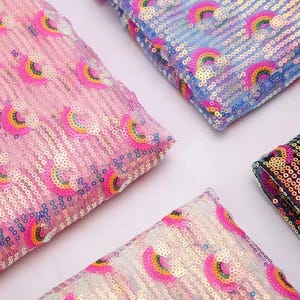 May include: Close-up of four fabric swatches covered in sequins. Each swatch features a repeating rainbow design in pink, yellow, green, and blue. The sequins are arranged in a pattern, creating a shimmering effect. The fabric is likely used for apparel or craft projects.