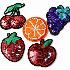 May include: A collection of five sequined fruit patches: cherries, an orange slice, grapes, a strawberry, and an apple. Each patch has a black border and features vibrant colors and detailed stitching. The patches are ideal for decorating clothing or accessories.