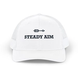 May include: A white trucker cap with a mesh back and a solid front panel. The front features a dark navy blue graphic of an arrow pointing right, positioned above the text STEADY AIM in a bold, capitalised, sans-serif typeface.