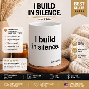 May include: White ceramic mug with the text "I build in silence" in black. The mug is 330 ml and is microwave and dishwasher safe. The mug is on a wooden coaster, with the words "Watch later" below the text.