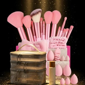 May include: A pink makeup brush set with various brushes, sponges, and a cosmetic bag. The set includes a headband and a bottle of makeup setting spray. The text "THE VIRAL OR" and "COMBO 0219" are visible.