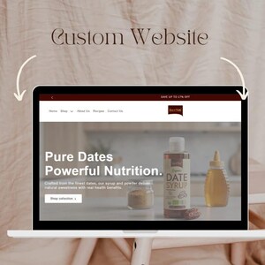May include: A laptop displaying a website with the text "Custom Website." The website features the words "Pure Dates Powerful Nutrition" and images of date syrup and other products. The website also includes the text "Shop collection."