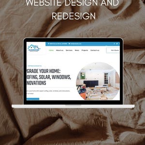 May include: A laptop displaying a website design with the text "WEBSITE DESIGN AND REDESIGN" at the top. The website features a blue and white color scheme with the company logo and the words "GRADE YOUR HOME: ROOFING, SOLAR, WINDOWS, RENOVATIONS".