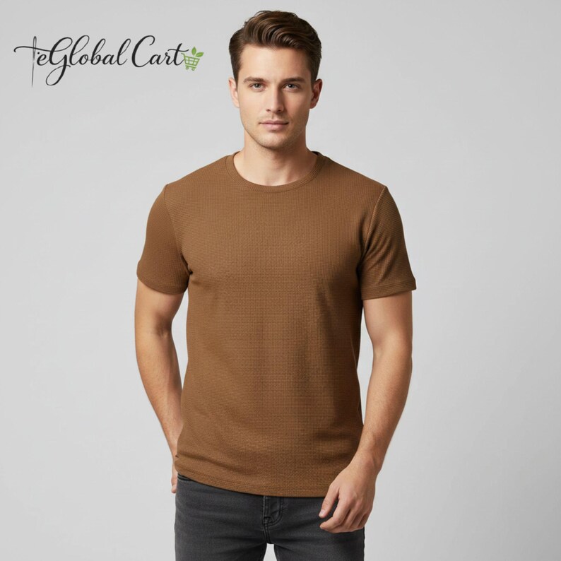 May include: A brown short-sleeved t-shirt with a textured pattern. The shirt has a crew neck and is worn with dark gray jeans. The image includes the text "eGlobal Cart" in cursive script.