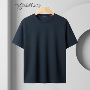 May include: A navy blue short-sleeve t-shirt with a textured pattern. The shirt has a crew neck and is hanging on a wooden hanger. The Global Cart logo is visible in the upper left corner.