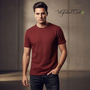 May include: A burgundy crew neck t-shirt. The short-sleeved shirt is made of a textured fabric. The model is wearing dark wash jeans. The text "TeGlobal Cart" is in the upper right corner.