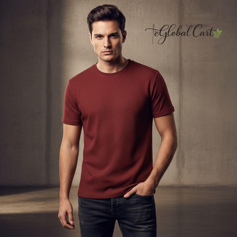 May include: A burgundy crew neck t-shirt. The short-sleeved shirt is made of a textured fabric. The model is wearing dark wash jeans. The text "TeGlobal Cart" is in the upper right corner.