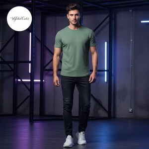 May include: A person wearing a green crew neck t-shirt and black distressed jeans. The person is also wearing white sneakers. The Global Cast logo is in the upper left corner.