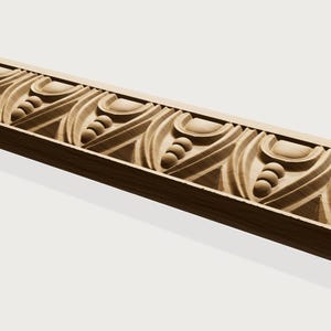 May include: A light-colored wooden molding strip featuring a repeating carved pattern. The design consists of alternating arched shapes and vertical rows of three small spheres, all set within a linear, textured wooden border.