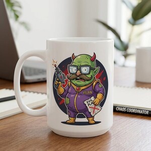 May include: White ceramic mug with a cartoon villain design. The villain is green with horns, glasses, and a mustache, holding a ray gun and a paper that says "EVIL PLAN". The mug has a large handle and a black and red background.