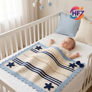 May include: A cream-colored crochet baby blanket featuring navy blue horizontal stripes, a light blue scalloped border, and navy blue star-shaped appliqués. The blanket includes a row of raised bobble stitches and a small navy blue bow accent.