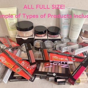 May include: A collection of various cosmetic products, including tubes of lotion, jars of powder, and makeup pencils. The image features multiple Revlon products, with text that reads "ALL FULL SIZE! Example of Types of Products Included!"