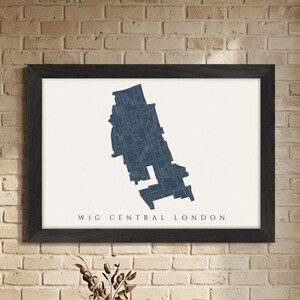 May include: A framed map print of WIG Central London in navy blue. The map is set against a cream background and is enclosed in a black frame. The text "WIG CENTRAL LONDON" is printed below the map.