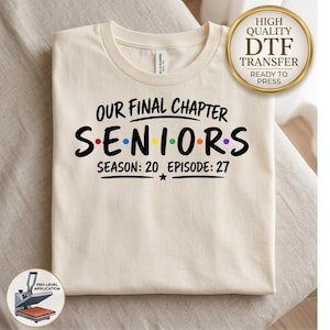 May include: A cream-colored t-shirt featuring black text that reads OUR FINAL CHAPTER SENIORS with colorful dots between the letters of SENIORS and the text SEASON: 20 EPISODE: 27 below. A gold circular badge in the corner reads HIGH QUALITY DTF TRANSFER.