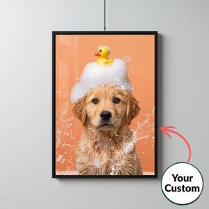 May include: A framed wall art print featuring a golden retriever puppy with wet fur covered in white soap bubbles and a small yellow rubber duck on its head. The background is a solid peach color with water splashes surrounding the puppy.
