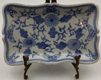 Bandeja de servir vintage de porcelana azul y blanca con motivos florales y de mariposas.