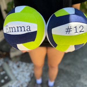 Personalized name and/or number of the player on soft fleece plush volleyball.