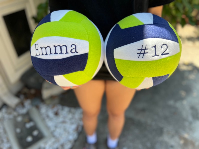 Personalized name and/or number of the player on soft fleece plush volleyball.