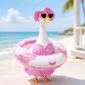 May include: A white goose figurine wearing a pink polka-dot sun hat, heart-shaped sunglasses, and a matching pink polka-dot bikini top. The goose is positioned inside a pink and white inflatable swim ring with a glittery interior and orange feet.