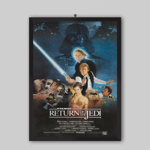 May include: A framed movie poster for Star Wars: Return of the Jedi. The poster features Darth Vader, Luke Skywalker with a lightsaber, Han Solo, Princess Leia, and other characters. The title is prominently displayed.
