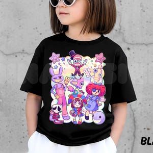 May include: A black t-shirt featuring a colorful cartoon graphic of various characters. The graphic includes a purple rabbit, a character in a top hat, and other whimsical figures. The word "BLACK" is printed in white on the bottom right.