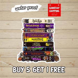 May include: A sticker featuring a stack of classic Halloween-themed VHS tapes including The Addams Family, Hocus Pocus, Beetlejuice, Halloweentown, The Nightmare Before Christmas, Goosebumps, It's The Great Pumpkin, Charlie Brown, and The Witches.