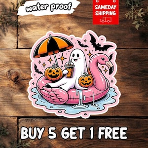May include: A die-cut sticker featuring a white ghost sitting on a pink flamingo pool float in blue water. The ghost holds an iced drink, flanked by two orange jack-o'-lanterns and a black and orange striped umbrella, with black bats overhead.