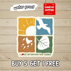 May include: A square sticker featuring four quadrants with white icons: a sun in a yellow square, a bird in a blue square, raindrops in a brown square, and a leaf in a green square. The text reads I LOVE INTERPRETIVE SIGNS with a red heart icon.