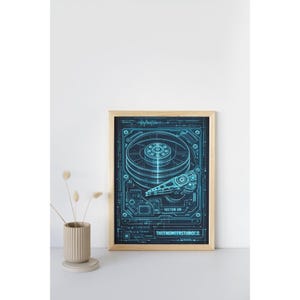 May include: A framed wall art print featuring a technical blueprint illustration of a hard drive disk in glowing cyan blue lines on a dark background. The design includes intricate mechanical details, the text SECTOR 09, and THEENGINEERSTUDIOCO.
