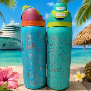 May include: Two turquoise Owala water bottles with laser-engraved tropical designs. The left bottle features a pineapple, flamingo, and the text Margaritaville at Sea. The right bottle displays a coconut, hibiscus, and Cruisin with my Homie.