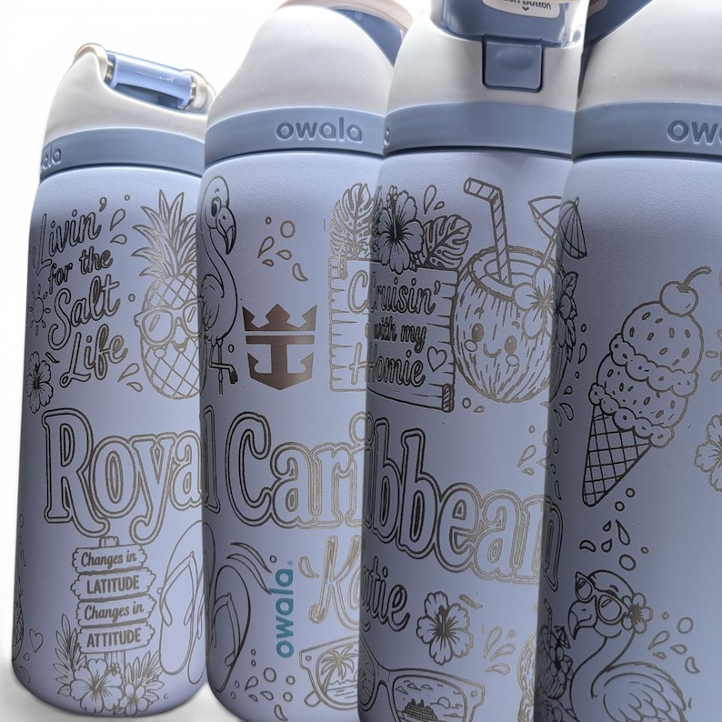 May include: Four light blue Owala water bottles with white lids and blue accents. Each bottle features engraved tropical designs including pineapples, flamingos, ice cream, and text such as Livin' for the Salt Life, Royal Caribbean, and Changes in LATITUDE.