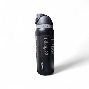 May include: A matte black 32 oz Owala water bottle with a gray lid and a black carry loop. The bottle features a black product label with white text and diagrams detailing the FreeSip spout, including the text Hi there, I'm leak-free, I'm insulated.