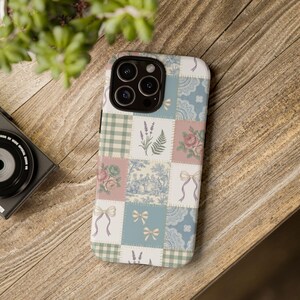 May include: A smartphone case featuring a patchwork design of various squares. Patterns include green and white gingham, lavender sprigs, pink roses, blue toile scenes, white lace motifs, and light blue ribbons on a soft pastel background.