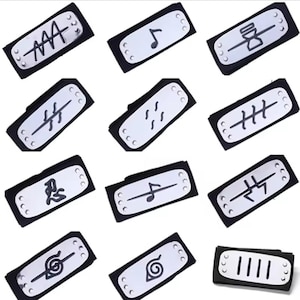 May include: A collection of black headbands with silver metal plates featuring various black symbols. The headbands are rectangular with rounded corners and are arranged on a white surface. The symbols include musical notes, lines, and abstract designs.