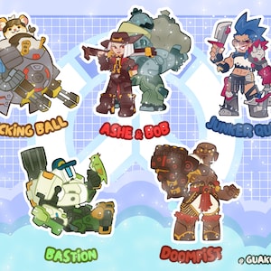 May include: A set of five character stickers featuring Wrecking Ball, Ashe and Bob, Junker Queen, Bastion, and Doomfist. Each character is illustrated in a chibi style with vibrant colors and outlines. The text labels for each character are included below them, and the brand name Guakocharms is printed in the bottom right corner.