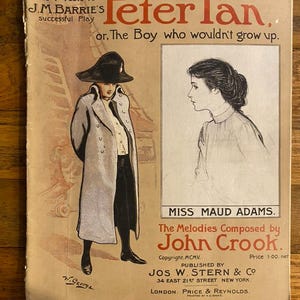 May include: Vintage sheet music cover for "Peter Pan, or, The Boy Who Wouldn't Grow Up." The cover features illustrations of a character in a long coat and a woman's profile. Text includes the title, author, and publisher information.