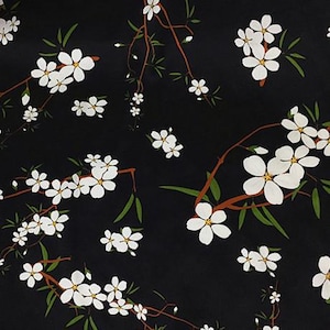 May include: A black fabric featuring a repeating pattern of white five-petaled flowers with yellow centers. The flowers are attached to thin brown branches with slender green leaves, creating a botanical design across the dark background.