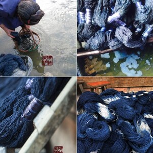 May include: A close-up of indigo blue yarn being dyed in a natural dye bath. The yarn is being rinsed in a river and then hung to dry. The yarn is a deep indigo blue color.