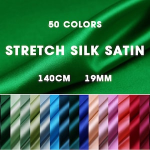 May include: A close-up of a green stretch silk satin fabric with the text "50 COLORS STRETCH SILK SATIN 140CM 19MM". The image shows a variety of colors of the fabric in a row below the text.