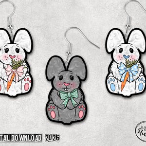 May include: Three bunny-shaped earrings with silver hooks. Two white bunnies and one gray bunny are holding carrots and wearing bows. The bunnies have pink and blue accents. The text "DIGITAL DOWNLOAD 2026" is at the bottom.