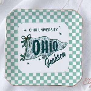 May include: Square decorative tray with a mint green and white chequered pattern. The centre features a pennant design with the text "OHIO UNIVERSITY" and "OHIO Jackson" in teal. The tray has a gold trim.