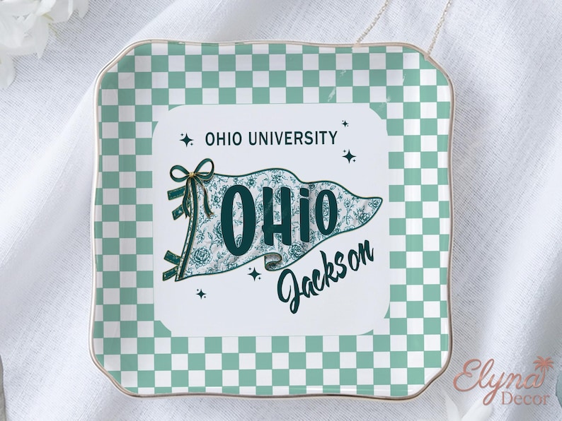 May include: Square decorative tray with a mint green and white chequered pattern. The centre features a pennant design with the text "OHIO UNIVERSITY" and "OHIO Jackson" in teal. The tray has a gold trim.