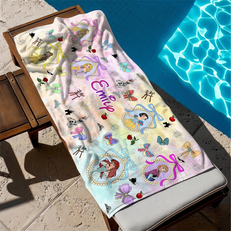 May include: A rectangular beach towel featuring a pastel watercolor background with the name Emily printed in purple script. The towel displays various Disney princess illustrations in ornate frames, colorful bows, red roses, and small castle icons.