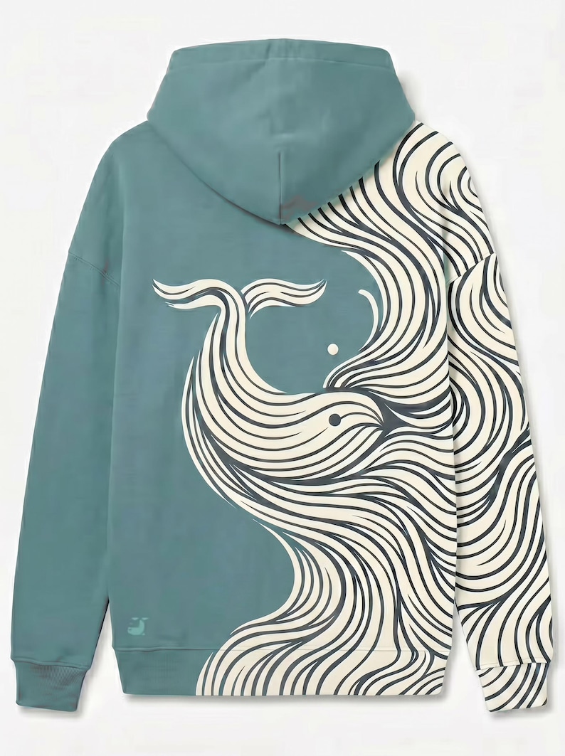 May include: Teal hoodie featuring a whale design. The back of the hoodie showcases a stylized whale illustration in cream and black, with flowing lines. The hoodie has a hood and long sleeves, and a small logo is visible on the lower left.