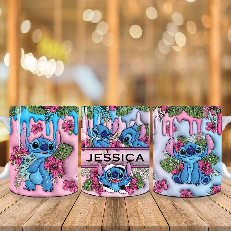 May include: Three ceramic mugs featuring the character Stitch from Lilo & Stitch. Each mug has a different design, with Stitch surrounded by flowers and tropical elements. One mug has the name "Jessica". The mugs are on a wooden surface.